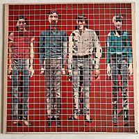 Front cover of Talking Heads More Songs About Buildings and Food vinyl album with grid overlay over band photo and red background.