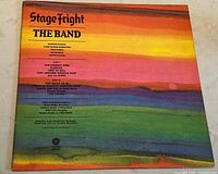 Front cover of The Band 'Stage Fright' vinyl album showing track listing and credits on a rainbow-colored background.