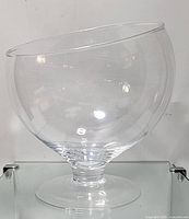 Front view of the clear glass plant terrarium bowl with slant cut opening on pedestal base, showing shape and clarity.