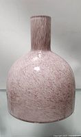 Front view of medium pink glass vase with textured pattern and glossy finish.