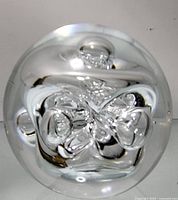 Top-down view showing the clear glass and internal abstract swirls and bubble design.
