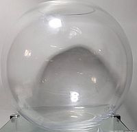 Clear spherical vintage glass fish bowl photographed from front, showing the round top opening and smooth transparent surface.