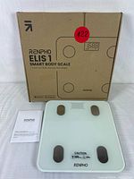 Photo of the RENPHO Elis 1 Smart Body Scale with box and manual, showing product branding and packaging.