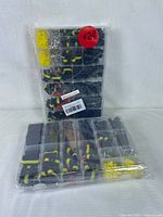 Photo of two sealed plastic organizer cases containing various black and yellow waterproof electrical wire connectors and terminals.