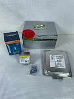 Photo showing the boxed Partszon Parts Maintenance Kit, Super Vision Xenon bulb box, small labeled component with anti-alarm sticker, and small screws against white background.