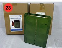 Two unopened cardboard boxes with labels showing automatic chicken coop doors, with one green coop door panel displayed in front.