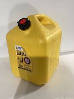Yellow 5 gallon diesel fuel can with red and black screw cap and visible label for diesel use