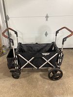 Side view of wagon unfolded showing fabric seating and frame