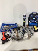Full view of the various hand tools including hammer, screwdrivers, wrench set, utility knife, flashlight, and blue handheld fan