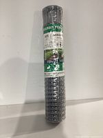 Full view of rolled galvanized wire rabbit fence with label showing dimensions and product name.