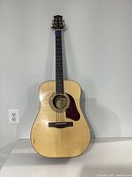 Full view of the Silvertone acoustic guitar showing natural wood body and dreadnought shape.