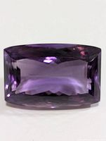 Top view of the faceted rectangular cushion-cut amethyst showing its clarity and deep purple color.