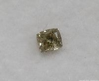 Close up photo of loose genuine diamond, approx 0.20ct, cushion cut on white background.