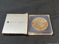 Front side of the 1995 silver dollar showing historical scene with man, settlement and ship commemorating Hudson Bay Company.