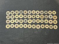 Front view of 48 copper coins arranged in rows, showing circular shape with central square holes and marked with Chinese characters.