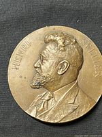 Close-up of obverse side showing left-facing portrait of Henri Sellier with artist signature and inscribed name.