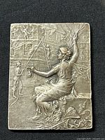 Front photo showing the detailed high-relief fire rescue scene with allegorical female figure.