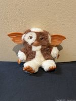 Front view of the NECA Gremlins Gizmo plush showing the soft fur, expressive eyes, and large ears.