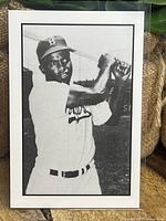 Front side of 1984 Renata Galasso baseball card featuring black and white image of Jackie Robinson batting in Brooklyn Dodgers uniform.