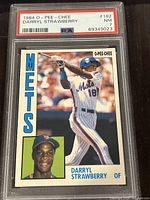 Front view of the 1984 O-Pee-Chee Darryl Strawberry rookie card showing player image and team name Mets, graded PSA 7 near mint.