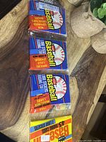 Three sealed 1988 Fleer Baseball rack packs stacked on wooden surface with burlap sack in background