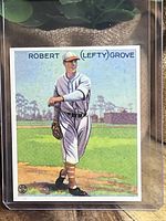 Front side of the card showing Robert 'Lefty' Grove in Philadelphia Athletics uniform on the baseball field.