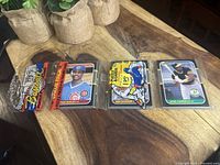 Four 1987 Donruss baseball cards in protective sleeves, including Jose Canseco rookie card and original sealed rack pack.