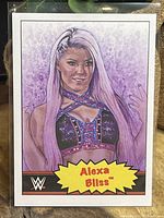 Front of the Alexa Bliss WWE 2021 Topps Living Set trading card showing colorful illustration of the wrestler.