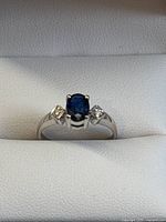 Front view showing oval sapphire and side diamonds