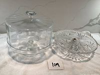 Lot showing both cake stands side by side, one with dome cover and one without.