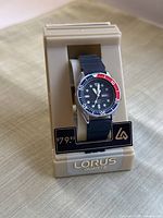 Overall view of the watch on original beige Lorus quartz stand with visible $79.95 price tag.