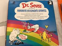 Dr. Seuss Favorite Children's Stories album cover with colorful characters and story titles visible