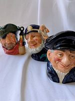 Photo showing the three Royal Doulton marine character jugs side by side, depicting smuggler, old salt, and lobster man characters.