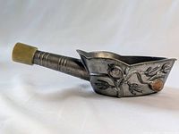 Full side view of the small Chinese silk iron showing the overall shape and stone handle.