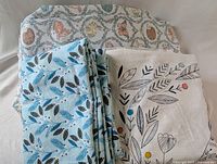 Stack of three sets of cotton fabric showing different patterns and colors