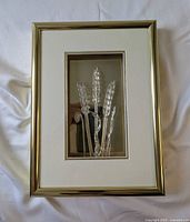 Full view of the framed glass wheat ears art showing the entire piece from a top-down angle.