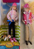 Full view of two dolls, one in box with dog and blue ribbon, the other dressed in western style clothing