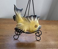 Front and side view of yellow and black ceramic fish wall pocket from Ceramicraft, showing details and condition