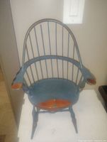 Wooden antique doll chair painted blue with natural wood accents on seat and arms, 12 inches tall