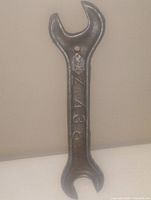 Photo of antique iron double open-end wrench showing markings 'Z136' on the handle, standing upright against a plain background.
