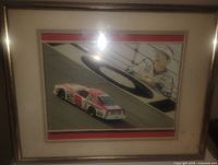Framed picture of Dale Earnhardt Sr. with race car and portrait.