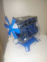 Blue display fan model shaped like a motor with visible wiring and plastic stand