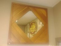 Front view of the square oak framed mirror showing chevron oak wood pattern and central reflective glass surface.