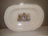 Plate platter showing full front with Royal Family design and embossing