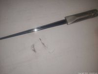 Close-up photo of the Royal Pewter letter opener showing the long slender metal blade and the detailed pewter handle.