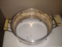Photo showing round vintage silver plated dish holder with French style handles and floral engraved decoration.