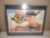 Framed picture showing Dale Earnhardt Sr. and Jr. with racing cars