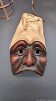 Front view of the international stoneware wall art mask showing facial features and coloring.