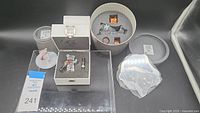 Wide view of all Swarovski crystal and fabric Christmas decorations with original packaging and protective foam inserts