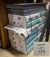 Stack of boxes labeled Goodfellow with loose tile sheets on top and MaSold lot marker